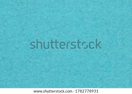 Teal textured cardstock paper closeup background with copy space for message or use as a texture 
