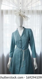 Teal Turquoise Blue Coat Dress, Kate Middleton Style Coat Dress In Teal Turquoise Color Along With Pearl White Waist Belt On A White Mannequin Shot In A Studio.