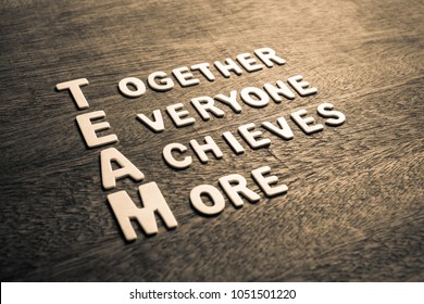 Team acronym and text Together Everyone Achieves More by wood letters on wood background - Shutterstock ID 1051501220