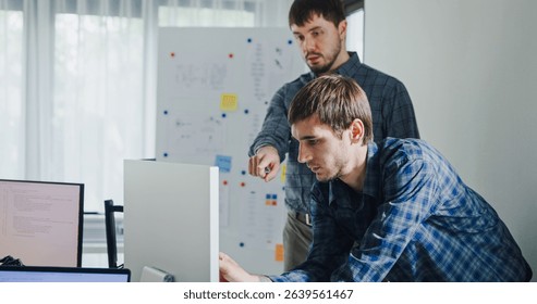 Team adult male engineer collaborate on robotic hand project using AI code solutions machine learning at tech workspace. Artificial intelligence interface, collaboration support prototype development. - Powered by Shutterstock - Get 15% off with code: PIKWIZARD15