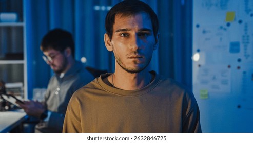 Team adult male freelance developer work late typing write prompt AI bot app program nomad terminal code at office night. Artificial intelligence dashboard, robotics, user interface, machine learning.