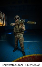 A Team Of Airsoft Players In The Old School Gym In Combat Positions