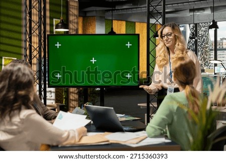 Team of ambitious shareholders collaborating with isolated copy space display in modern boardroom, strategic planning with data reports and infographics in a corporate work environment.