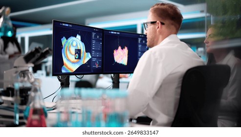 Team Of Analysts Using 3D Software For Research In Lab