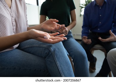 Team Of Anonymous Addicted Community Meeting For Group Therapy, Sitting On Chairs In Circle, Talking, Discussing Social, Mental Health Problems, Getting Counselling Help And Support. Close Up Of Hands