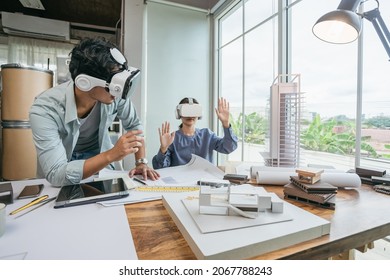 Team Architect or Engineer designer wearing VR headset for BIM technology working together design 3D model building in office. Technology futuristic virtual reality design.