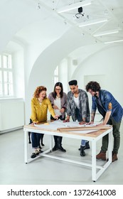 A Team Of Architects Collaborating On A Project Together