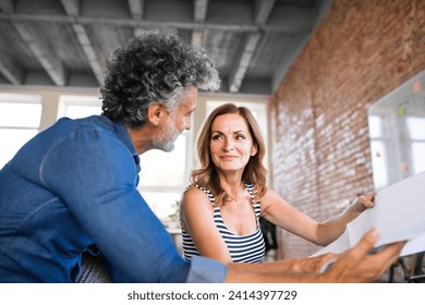 Team of architects discussing the rebuilding of a loft office - Powered by Shutterstock