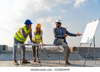 Team of architects people in group on construciton site check documents and business workflow - Shutterstock ID 2232833949
