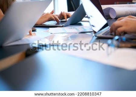 Team of architects using laptops at meeting