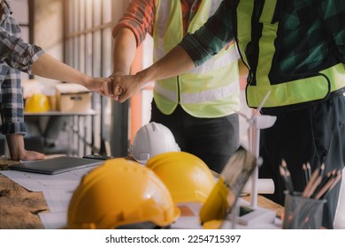 Team architects workers, men and women, join hands to join forces to join forces to work for the industry for success. Teamwork and professional colleagues : Workers' hands, teamwork concept. - Shutterstock ID 2254715397