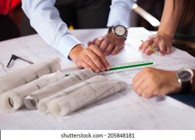 Team Of Architects Working On Construction Plans