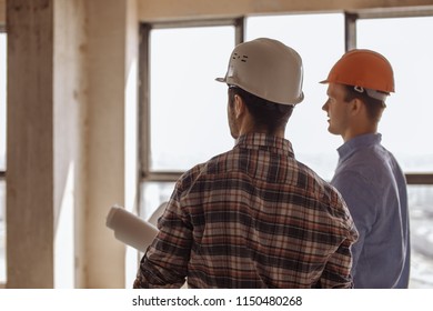 team arcitects looking at the working area. back view photo - Shutterstock ID 1150480268