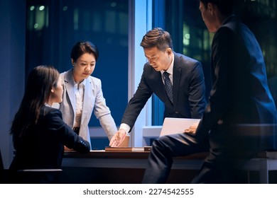 team of asian business people meeting in office reviewing performance and formulating strategy - Shutterstock ID 2274542555