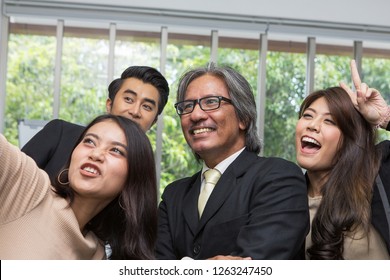 Team Of Asian Business Posing In Meeting Room. Woman Selfie In The Meeting Room At The Office.