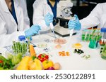 Team Asian scientists in a lab conducting food research using a microscope and lab equipment, showcasing innovation in food science and biotechnology