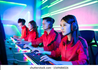 Team of asian teenage cyber sport gamers play in multiplayer PC video game on eSport tournament - Shutterstock ID 1569686026