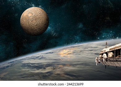 A team of astronauts work on a space station in orbit. An Earth-like planet sees the glow of its sun while a heavily cratered moon rises in the background. Elements of this Image Furnished by NASA. - Powered by Shutterstock