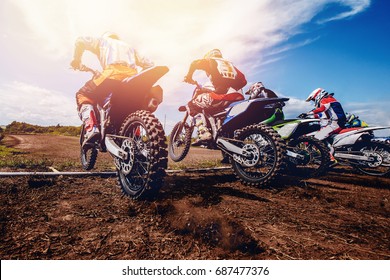  team of athletes on mountain bikes starts, smoke and dust fly from under the wheels cross-country. Concept active rest motocross. 