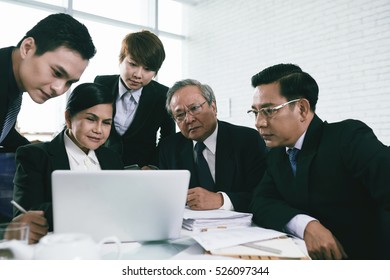 Team Of Attorneys Watching Something On Laptop Screen