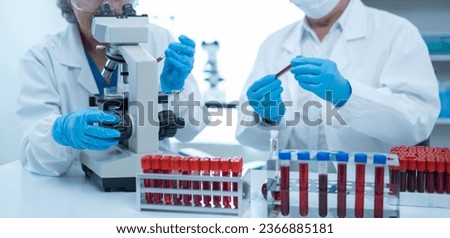 Team of biochemical research scientists working with a microscope for vaccine development in pharmaceutical research labeling. Zdjęcia stock © 