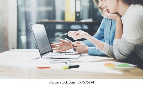 Team brainstorming. Photo young creative managers crew working with new startup project in modern office. Contemporary notebook on wood table. Statistics plans laptop screen. Horizontal, film effect - Powered by Shutterstock