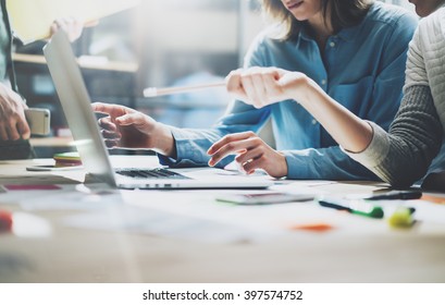 Team brainstorming process. Photo young creative managers crew working with new startup project in modern office. Contemporary notebook on wood table. Horizontal, film effect - Shutterstock ID 397574752