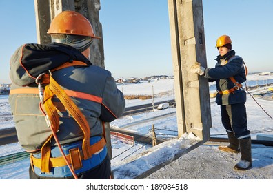 Team Of Builder Worker In Safety Protective Equipment At Winter Construction Site