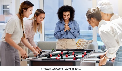 Team Building, Break And Business Women Playing Game In Office Lounge Room Having Fun And Bonding Together. Trendy, Cool And Diversity Of Creative Staff With Fun Mini Table Football Match Activity