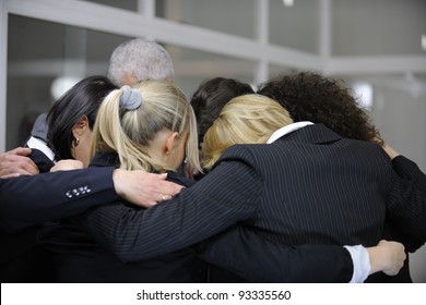 Team Building Event: Businessmen In 'group Hug' In Office