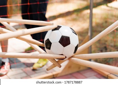 Team Building Game With Soccer Ball. People Touches Ball With Sticks. Games For Company