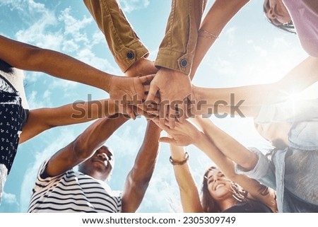 Team building, hands and low angle of business people in solidarity or partnership on blue sky background. Teamwork, agreement and below hand collaboration for motivation, help or friends celebration