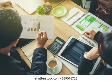 Team of business consulting, analysis of business plans. For profit and stability of business sustainability.Focus on hand Business man holding pen. - Shutterstock ID 559076716