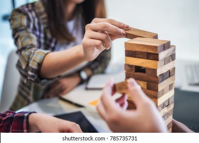 Team Business Hand's Plan And Strategy In Business, Risk To Make Buiness Growth With Jenga Wooden Blocks.