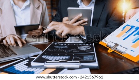 Team of business hands working on laptop with document paper sitting at desk in office in meeting room, Business team working with project statistics and present graphic info in room.