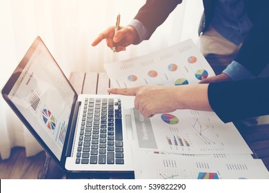 Team of business investment consultant analyzing company annual financial report balance sheet statement working with documents graphs. Concept picture of economy, market, office, money and tax.
