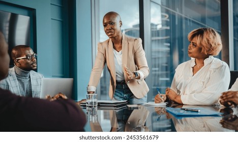 Team of business people having a business meeting within a modern office setting. Colleagues demonstrating teamwork, collaboration, active listening, leadership and effective communication. - Powered by Shutterstock