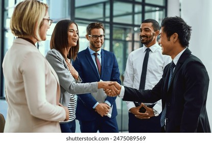 Team, business people and shaking hands for welcome, introduction or greeting in office. Handshake, smile and group with deal for collaboration, agreement or thank you for b2b partnership opportunity - Powered by Shutterstock