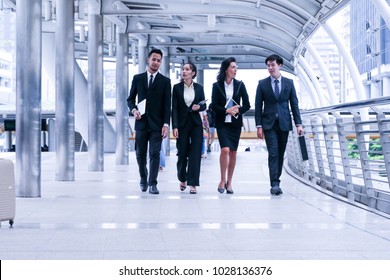 Team Of Business People Talking Or Discussion About Marketing Or Investment While Walking To Meeting Room Or Office