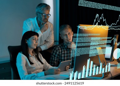 Team Of Business Professionals Analyzing Data And Graphs On Computer Screen. Concept Of Financial Analysis, Technology, And Collaboration. Men And Woman Working Together In Modern Office Environment. - Powered by Shutterstock