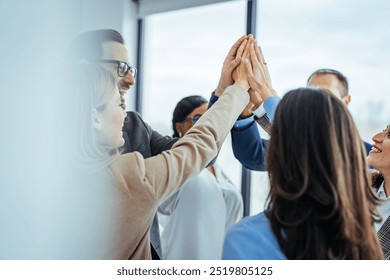 Team Celebrating Success with High Five in Office Environment - Powered by Shutterstock