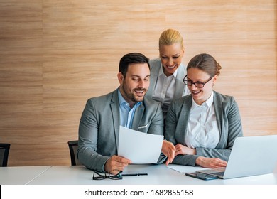 Team Of Cheerful Business People Working Together, Looking At Document, Portrait.