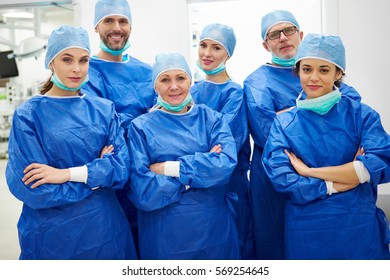 Team Of Cheerful Doctors In Surgical Uniform