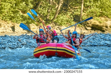 team of cheerful travelers are rafting on a boat on a stormy river
