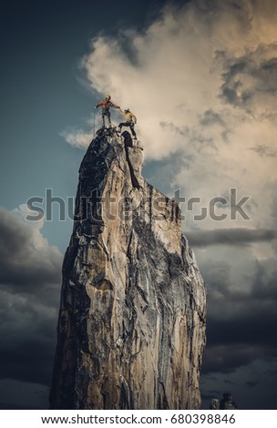 Team of climbers conquer the summit.