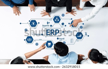 A team collaborates around a table, exploring the components of an ERP system. The image highlights digital strategy, planning, and payroll in a modern business context. Amity