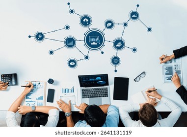 A team collaborates around a table utilizing technology and analytics to explore business data through charts, graphs, and productive discussions. Amity