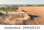 A team of combine harvesters Harvesting wheat aerial shot on field. Agricultural industry, subsidies for european farmers