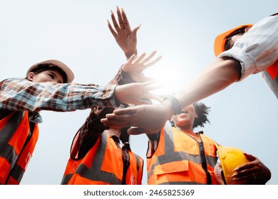 Team Construction or engineering group and worker. Teamwork and determination to succeed. Safety hard hat to prevent accident while working Transport and Container Team. Concept Restart and new Normal - Powered by Shutterstock