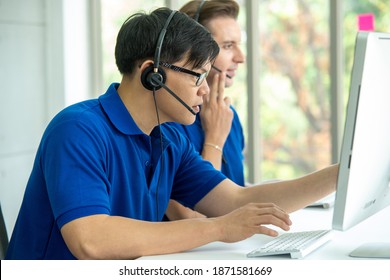 Team of customer service agent with headsets and computer working at workplace. - Shutterstock ID 1871581669